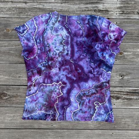 Back side of a geode tied shirt dyed in shades of purple. There are blue and pink splits included.