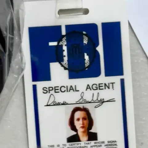 A close up photo of a replica of Dana Scully’s FBI ID tag.