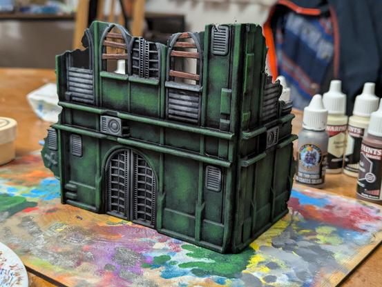 Painted Warhammer 40k scenery. A ruined green building.