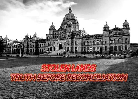 A grayscale photograph of the British Columbia Parliament Buildings in Victoria, BC. The buildings are large and ornate, constructed of stone, with a central dome and multiple smaller towers and turrets. Several windows are visible, including arched and rectangular shapes. People can be seen on the stairs.
Overlaid on the image in the foreground, in a red and orange gradient typeface, are the words "STOLEN LANDS" stacked above "TRUTH BEFORE RECONCILIATION." The text is bold and stands in contrast to the grayscale background. The sky is cloudy with some texture.