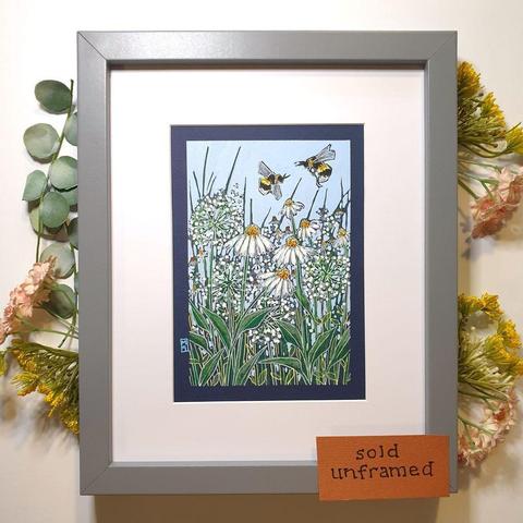 A small artwork featuring two bees flying over a mixed bed of white flowers. The drawing has a light sky blue background and is on dark blue paper.
An original art work
Colour pencil and mixed media on acid free toned artist paper
5 by 7 inches (12.7 by 17.8 cm).
Sold unframed