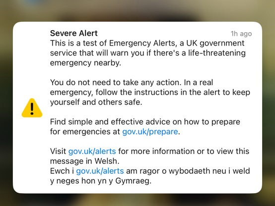 Text on a background describing the emergency alert test in UK