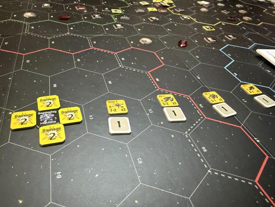 The final Doomsday Machine counter is surrounded by a fatal amount of damage counters. It faces an array of my ships, organized by attack order with each featuring the miner of ships in their respective fleets.