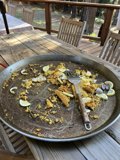 After-a nearly empty pan, scattered rice, clam shells, lemon slices