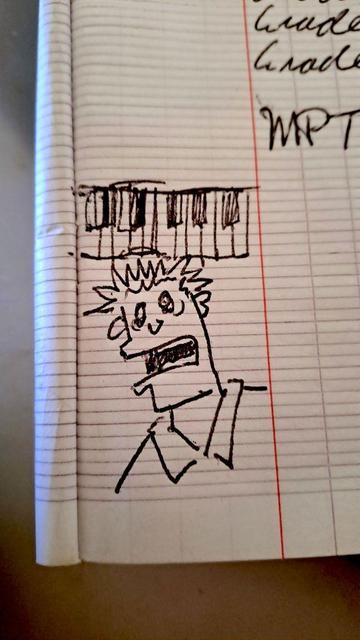 Marginal ball-point pen doodle in notebook of a stressed-out face under a piano keyboard.