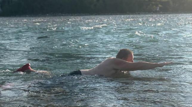 Me swimming in the Bow River, supporting myself with one hand while the rest of my body might look vaguely like I were flying if you looked at it through silly glasses