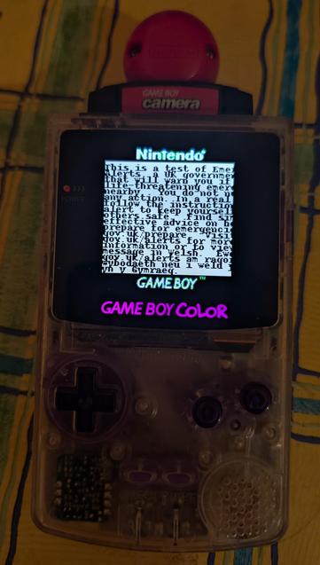 Game Boy Color showing  the text "This is a test of Emergency Alerts, a UK government service that will warn you if there's a life-threatening emergency nearby.

You do not need to take any action. In a real emergency, follow the instructions in the alert to keep yourself and others safe.

Find simple and effective advice on how to prepare for emergencies at gov.uk/prepare.

Visit gov.uk/alerts for more information or to view this message in Welsh."