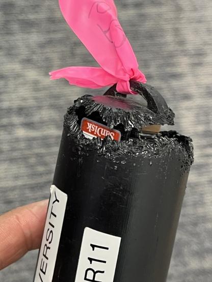 A photo of one end of an audio recorder with the plastic gnawed right through, almost all the way around the unit, exposing the SD card and electronics. It's definitely not waterproof now!