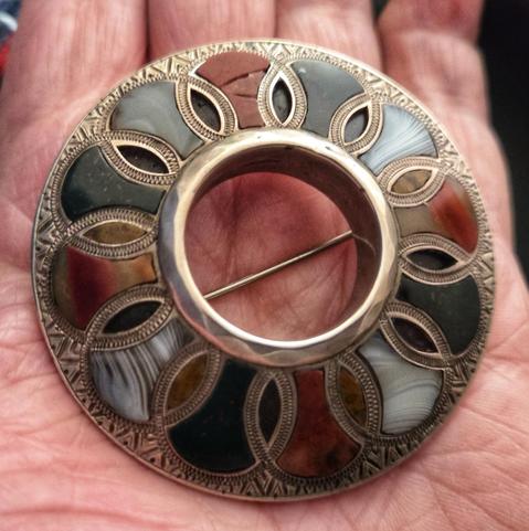The brooch in my hand to give an idea of its size. It’s just over 3 fingers wide!