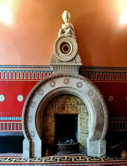 A stunning Victorian fireplace in the shape of the Greek letter omega.