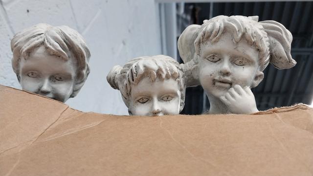 The stone youths stare longingly at you