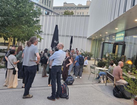 People chatting in front of a restaurant
