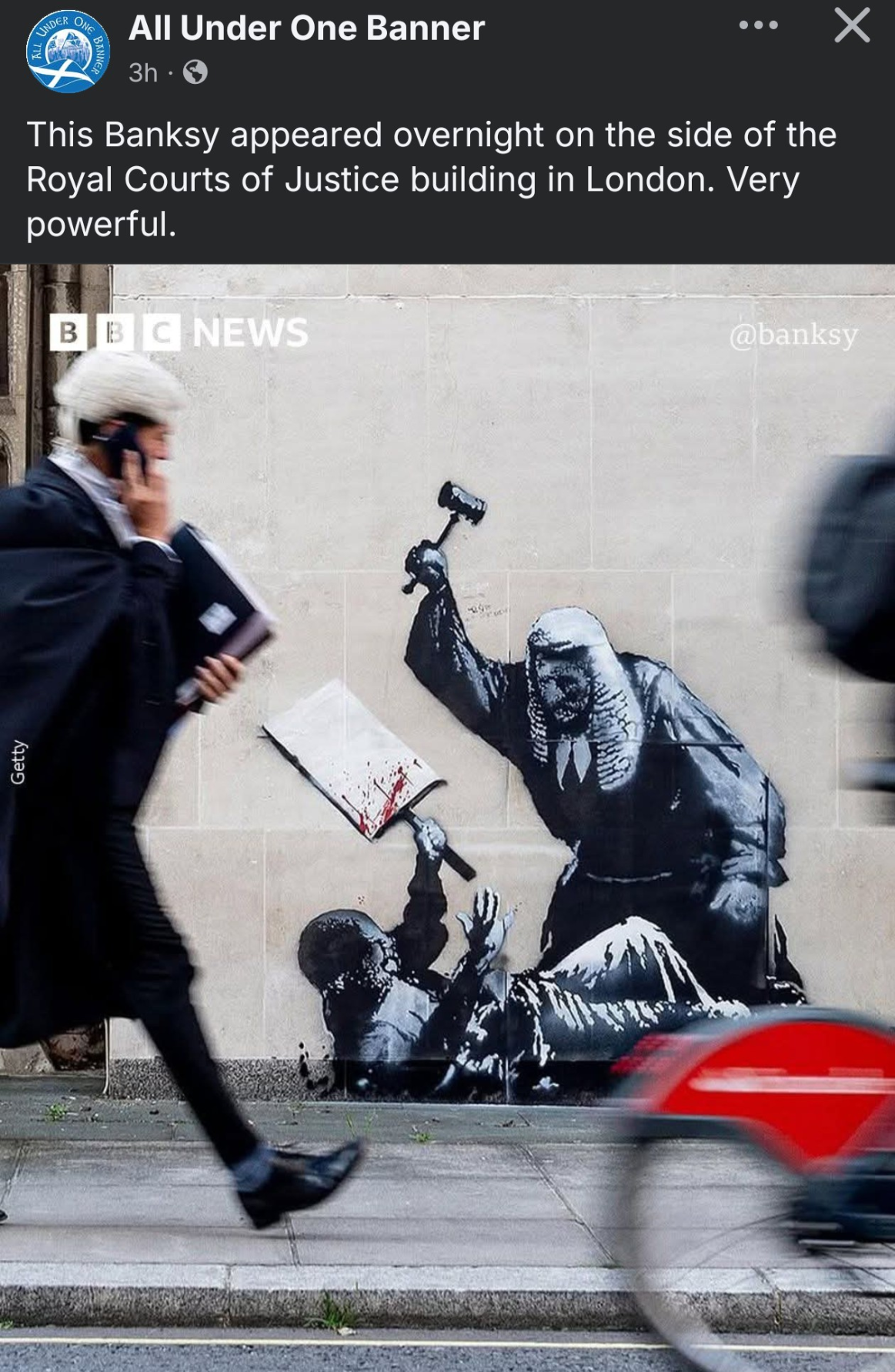 Banksy image on the side of the Royal Courts of Justice building. Image is a judge with their gavel beating down on a protester