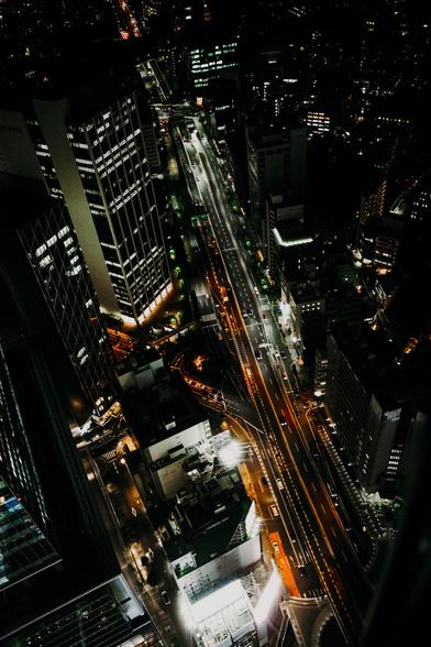 photo of Tokyo from above during the night, with a lot of lights and brightly lit streets