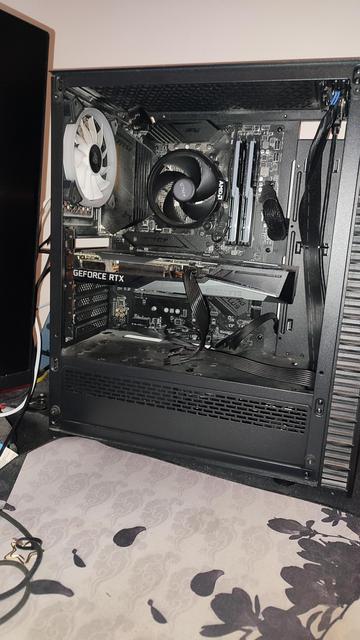 Offener PC von einer Seite. Man erkennt einen Haufen Lüfter und die dicke Grafikkarte in der Bildmitte. Unten ist ein geschlossener Kasten.