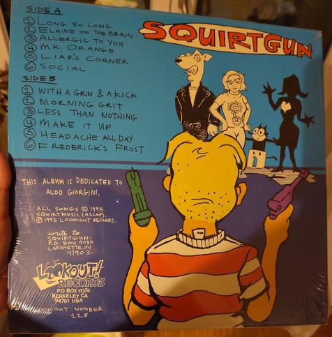 backside, you see the guy from behind aiming at the Mascots of Screeching Weasel, green day, The Queers and another one. and a list of all the songs