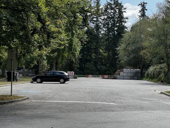 A wide view of a parking lot on Prospect Point where the back half is closed to store dirt.