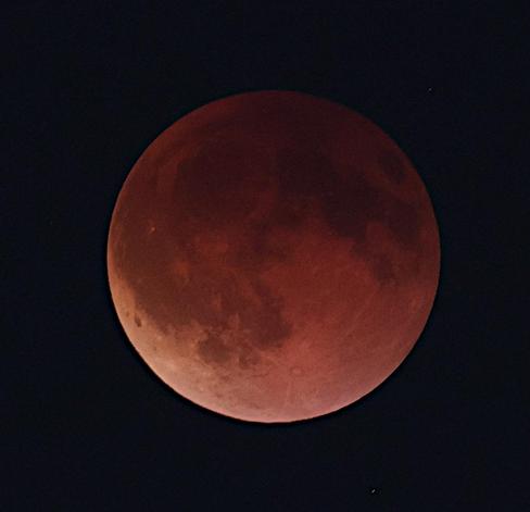 A telephoto (300mm) of eclipsed red Moon, cropped closer to the subject.