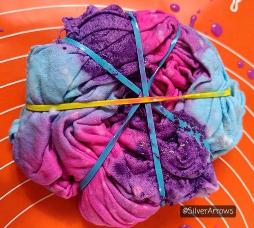 The still tied-up fabric after pouring on the diluted acrylic. I used cyan, magenta and violet.