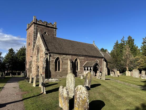 The church in Kingstone in the sun with a blue sky behind it.