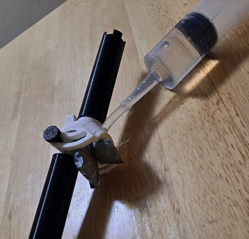 One of the two-pillow bladders installed in a 3d-printed spade joint, actuating it such that the joint is lifted out of its neutral position.