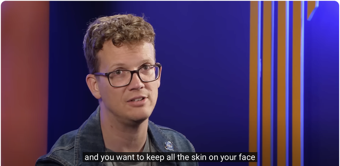 Hank Green from SciShow glancing to his right and addressing the viewer. Below him is the caption, "and you want to keep all the skin on your face."