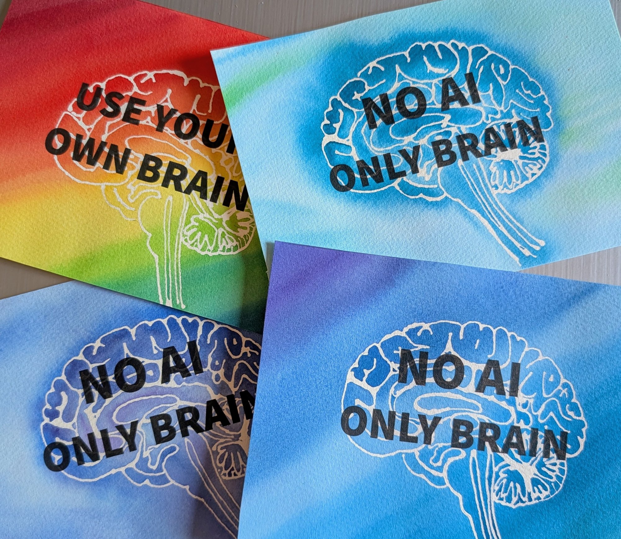 Four watercolor paintings with brains and anti AI messages