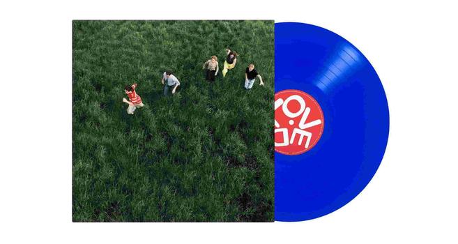 Parcels album Cover with blue vinyl LP. Band in green field. Center label of record says Loved in red circle.