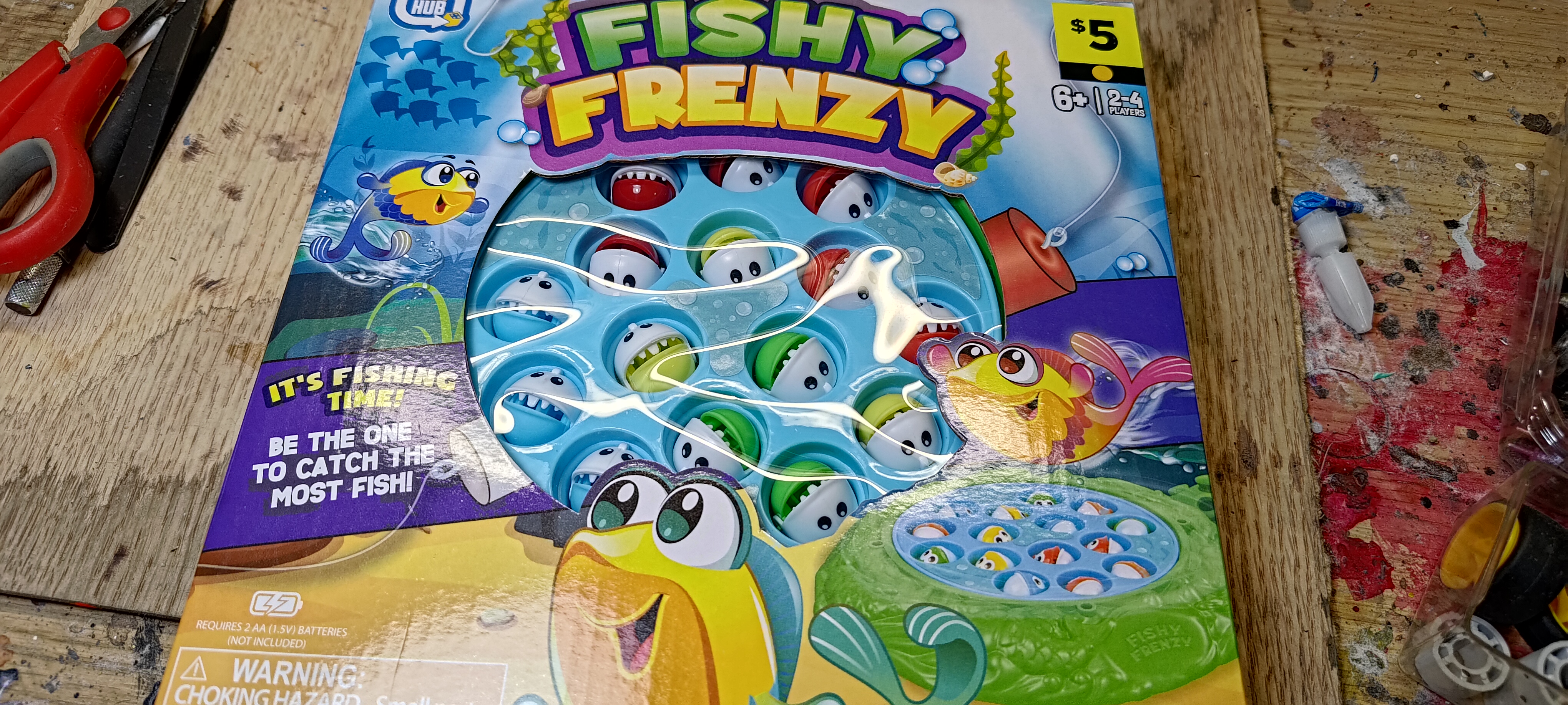 $5 toy called Fishy Frenzy. It's the typical little game where it rotates around and the fish open and close their mouths. They have cartoony eyes and big teeth.