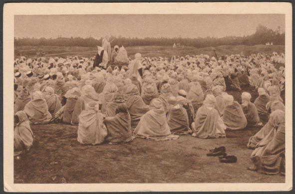 Printed sepia postcard showing a view of a large group of men in Algeria attending a lecture regarding the Koran.
Published by A. Bougault, Editions Horizons de France, No 1014, c.1920.
Postally unused.
Good condition, with slight corner bumps.