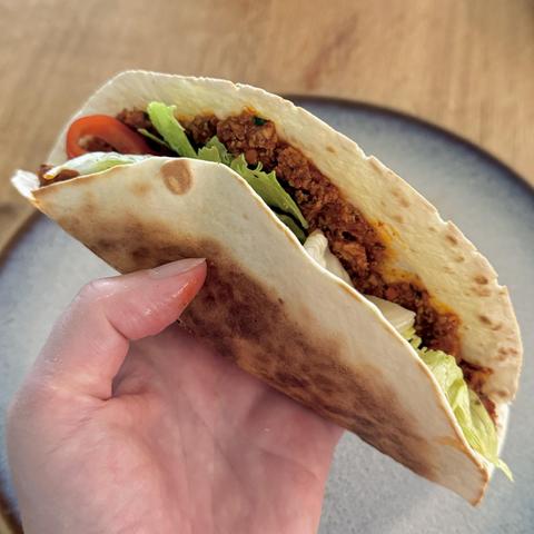 The taco like looking Lahmacun in my hand, browned outside from being in the frying pan.