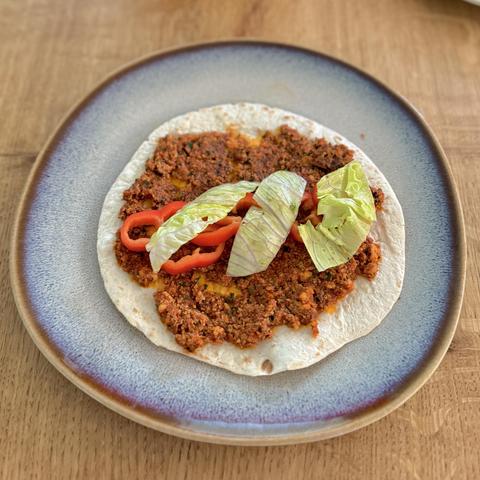 The Lahmacun on my plate with extra fillings on top.