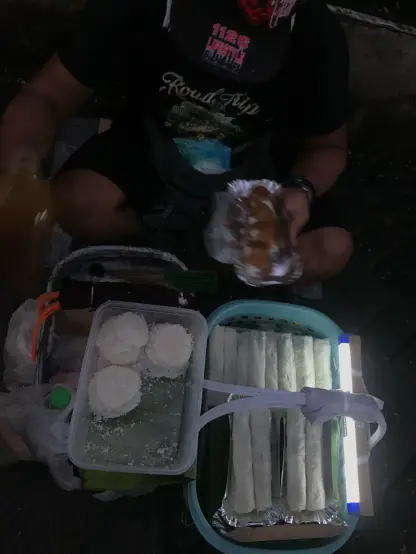 a man selling Filipino snacks, palitaw and fresh lumpia