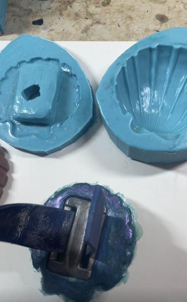 Back side of the shell showing a dive weight inserted into a cavity in the back