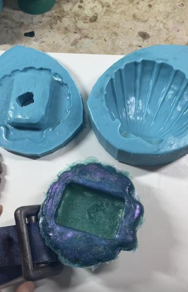 The back side of the shell, showing the empty cavity where the dive weight would fit. 

The inside of the shell mold appears in the upper right corner