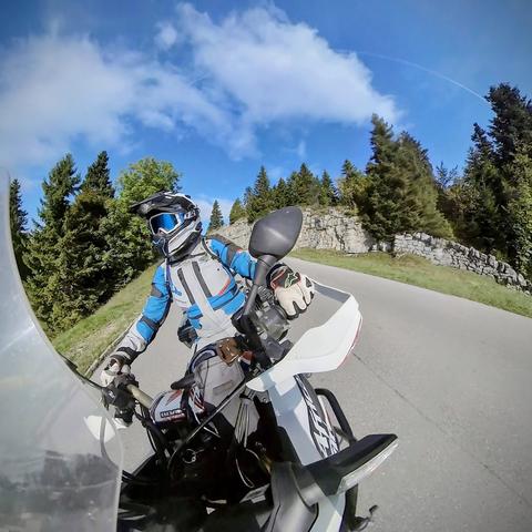 a motorcycle rider taking a right curve