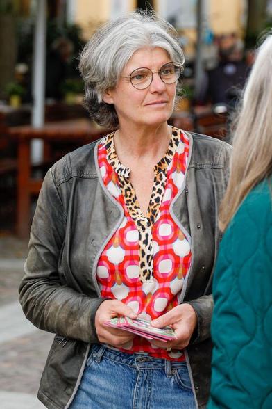 Fotografie von Simone Holderried im Gespräch mit einer andern Person. In der Hand hält sie Wahlkampfflyer.