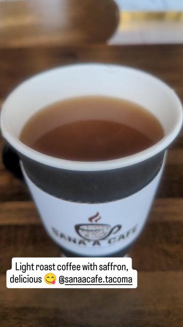 a coffee cup with a label for Sana'a Cafe