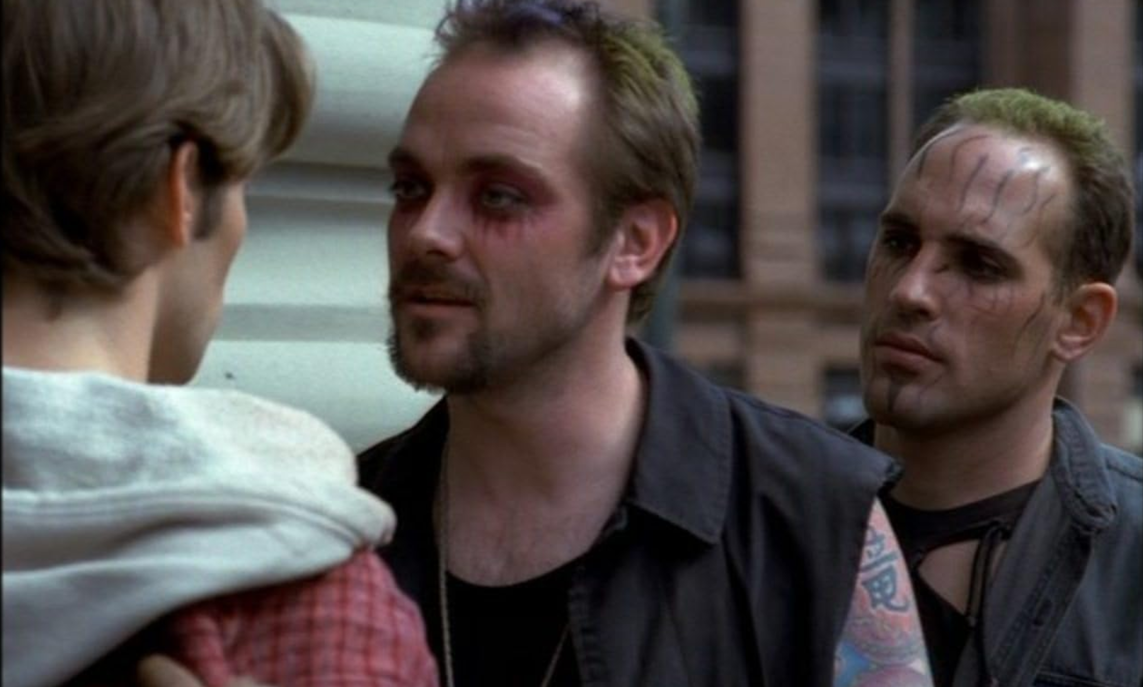 When you forget to alt-text your images on a public post. Two tattoed thugs wearing facepaint and eyeshadow intimidate someone new in town.