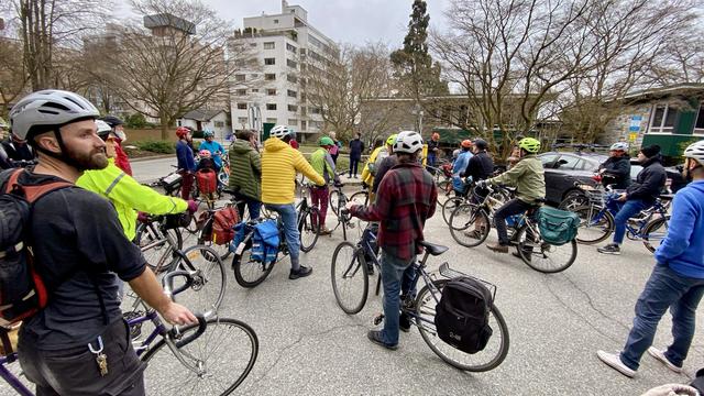 A group of cyclists behind the Park Board office on Beach Ave. listen to a ride organizer before departing for a ride around Stanley Park Drive to protest the removal of the bike lane in 2023.