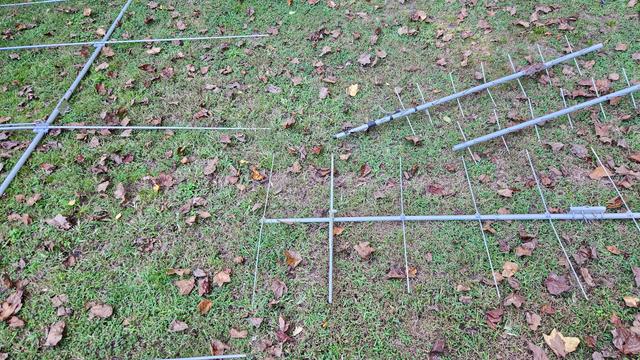 Six meter, two meter, and 70 centimeter yagi antennas laying on the ground.