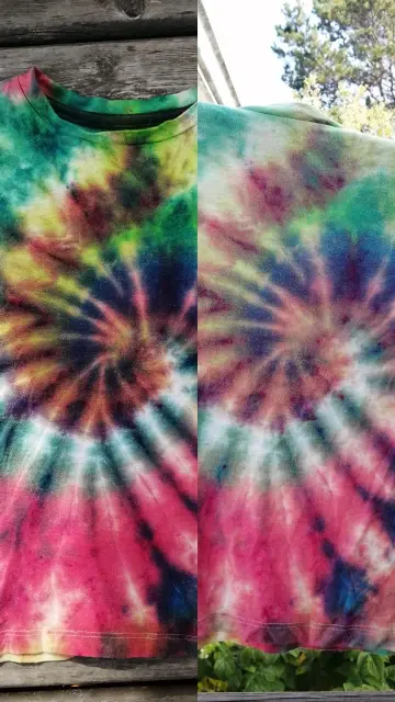 A side by side comparison of a tie dyed spiral in red, green, black, blue and yellow before and after rinsing - with some interesting colour mixing. The after photo looks a bit more faded than the before photo.
