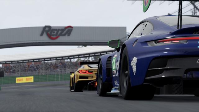 A Porsche following a Corvette closely
