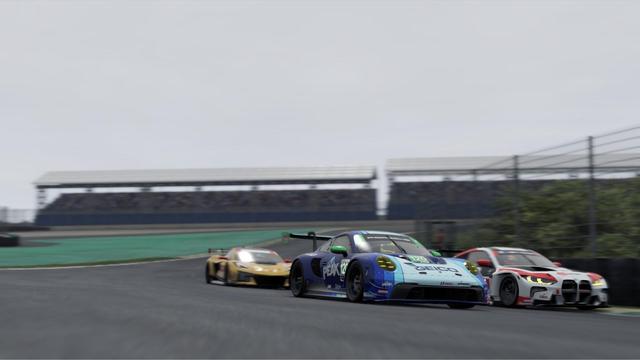 A Porsche, Corvette and BMW racing closely