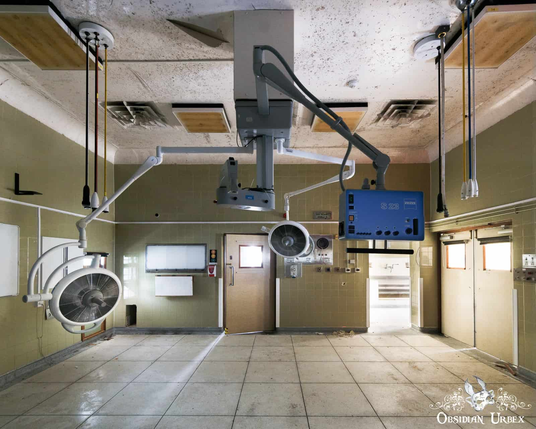 Operating theater with lights and control panel on arms from ceiling