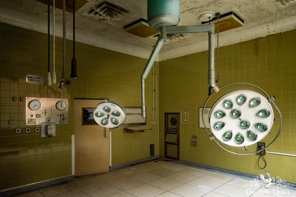 operating theater lights on arms, walls are olive tiles