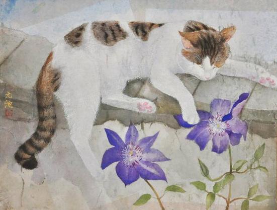 A sleepy cat naps on top of a stone wall, with its head resting on its front, left paw and right back paw sticking out over the ledge. Mostly white with tan and black tiger stripe patches on the top of its face, neck and ears; tail, and smaller patches on the top of its back. In front to the right are two large purple flowers with light green leaves.