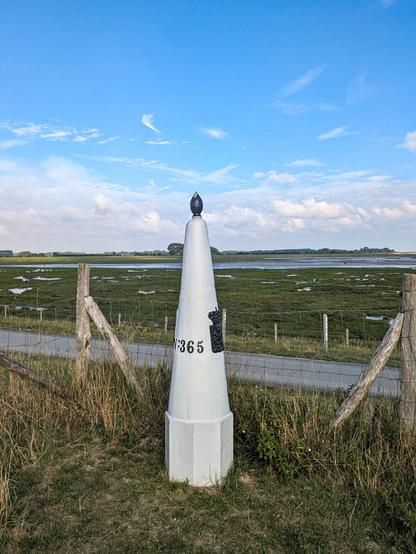Color photo of a 19th century border marker at the belgian-dutch border near Cadzand