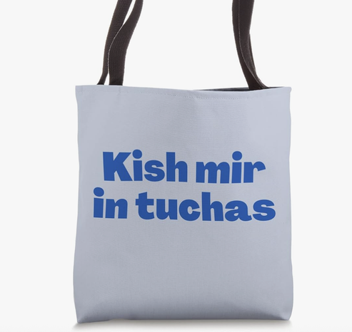 Kish mir in tuchas is shown in blue lettering on a tote bag.