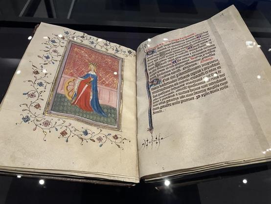 Page from the Book of Hours, illuminated by the Master of the Tall Figures (Beaufort group), showing a representation of Catherine of Alexandria, with a wooden wheel and a sword.